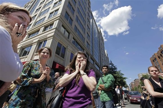 Office workers gather on the sidewalk in downtown Washington after a 5.9-magnitude earthquake on Aug. 23. The East Coast earthquake left more than just residents unaccustomed to feeling the ground shake in a daze. It also surprised scientists who spend their careers trying to untangle the mysteries of sudden ground shifts. 